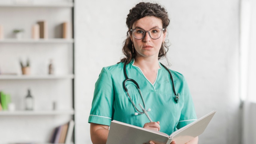 A healthcare professional wearing green medical scrubs