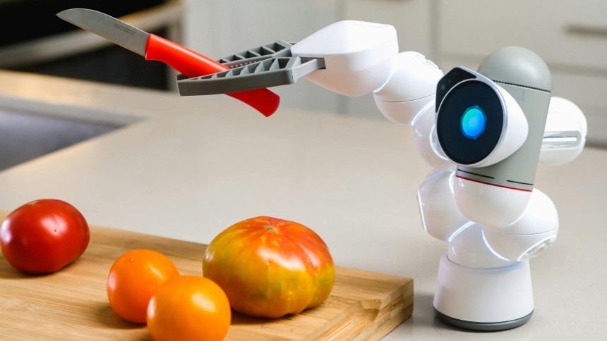 A robot cutting tomatoes showcasing on how kitchen technology integrates AI to streamline cooking processes